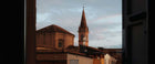 Historic Modena rooftops during summer, the Italian city where Schedoni leather craftsmanship began